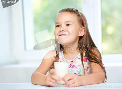 Image of Cute little girl with a glass of milk