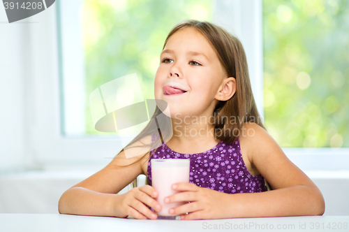 Image of Cute little girl with a glass of milk