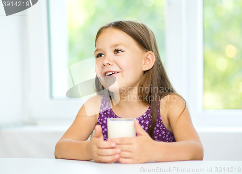 Image of Cute little girl with a glass of milk