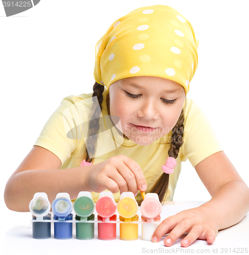 Image of Cute thoughtful child play with paints