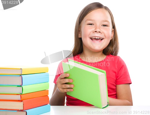 Image of Little girl is reading a book