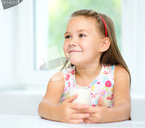 Image of Cute little girl with a glass of milk