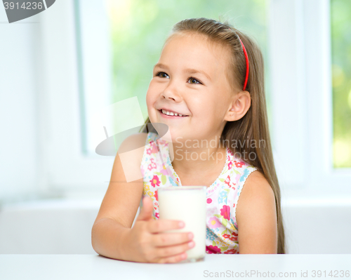 Image of Cute little girl with a glass of milk