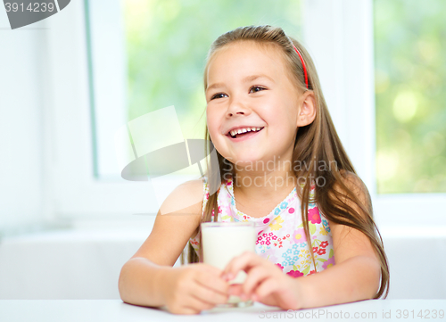 Image of Cute little girl with a glass of milk