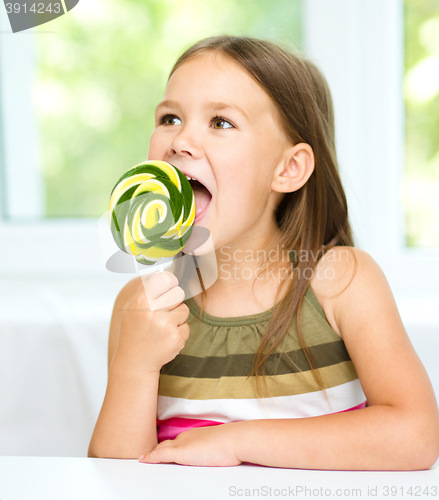 Image of Little girl with lollipop