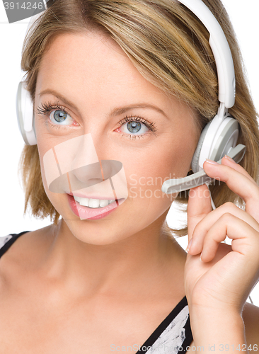 Image of Lovely young woman is talking to customers