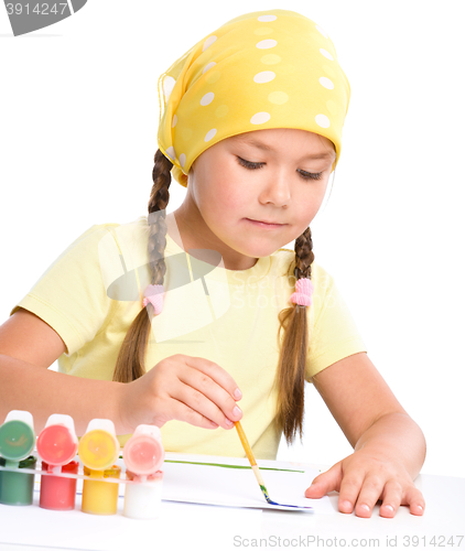 Image of Cute thoughtful child play with paints