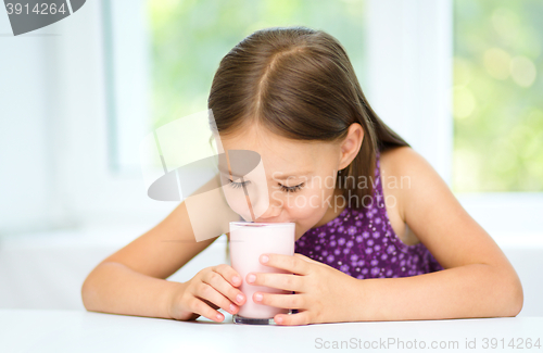 Image of Cute little girl with a glass of milk