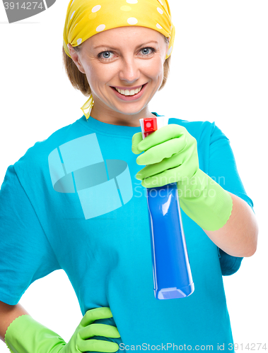 Image of Young woman holding cleaning spray