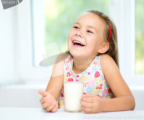 Image of Cute little girl with a glass of milk