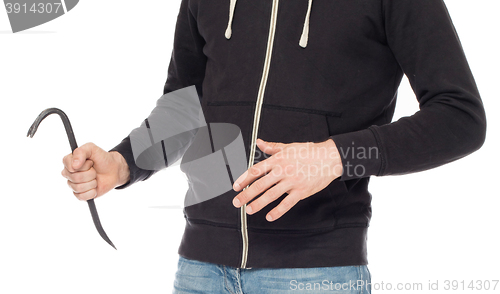 Image of Crime concept. Criminal in hood with crowbar in hand