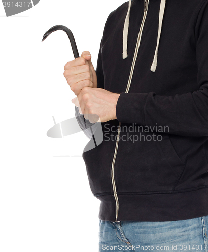 Image of Crime concept. Criminal in hood with crowbar in hand