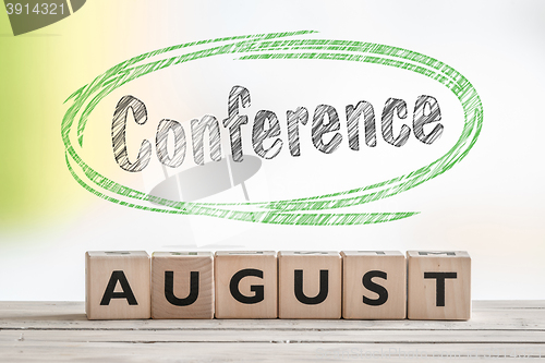 Image of August conference sign on a scene