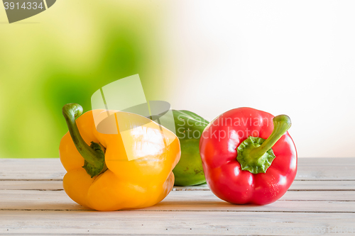 Image of Colorful peppers on a wooden table