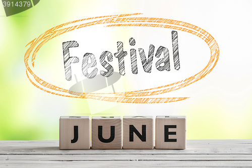 Image of June festival sign on a wooden stage