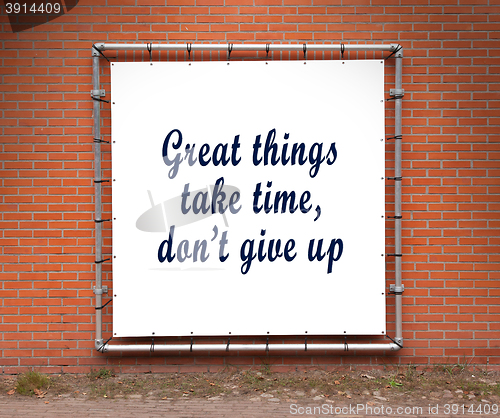 Image of Large banner with inspirational quote on a brick wall