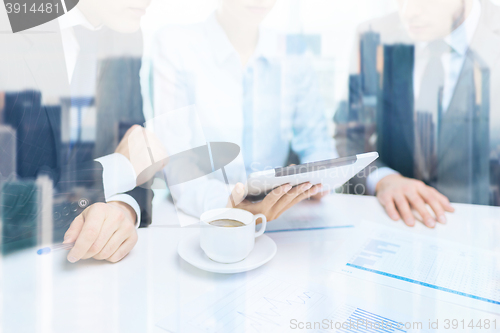 Image of business team with graph, tablet pc and coffee