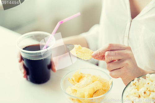 Image of close up of woman with junk food and coca cup