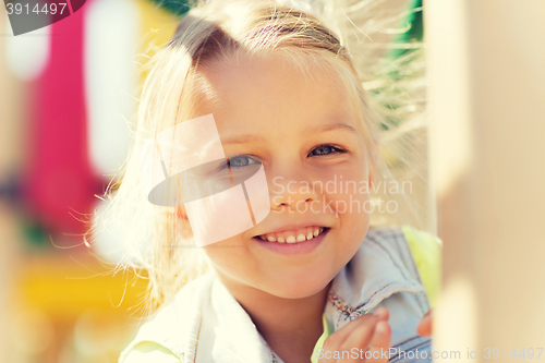 Image of happy little girl climbing on children playground