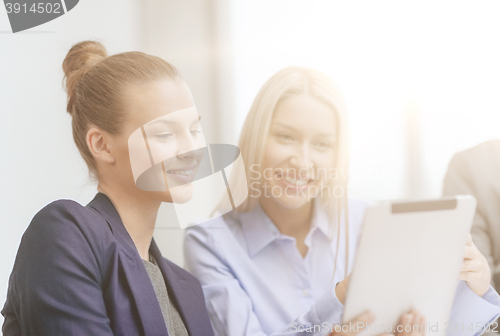 Image of business team with tablet pc having discussion