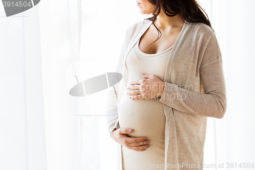 Image of close up of pregnant woman looking to window