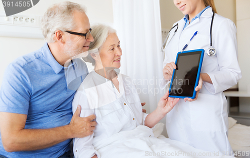 Image of senior woman and doctor with tablet pc at hospital