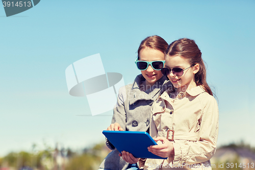 Image of happy girls with tablet pc computer outdoors