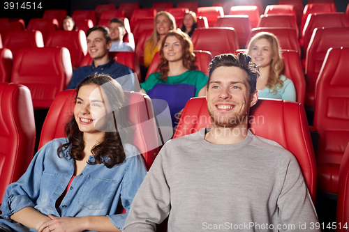 Image of happy friends watching movie in theater