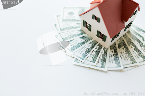 Image of close up of home or house model and money