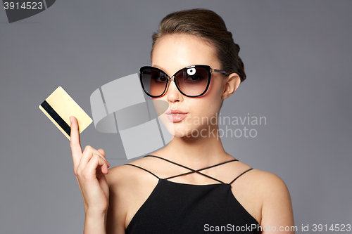 Image of beautiful young woman in elegant black sunglasses