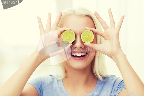 Image of happy woman having fun covering eyes with lime