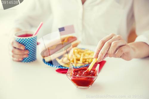 Image of close up of woman eating on american food
