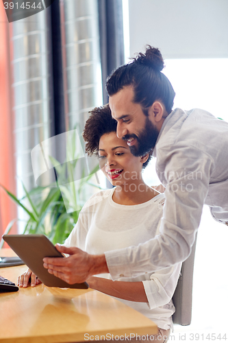 Image of happy creative team with tablet pc in office