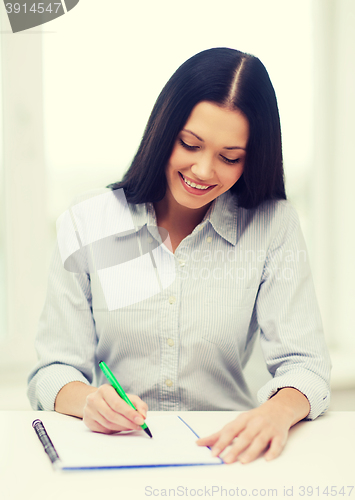 Image of smiling businesswoman or student studying