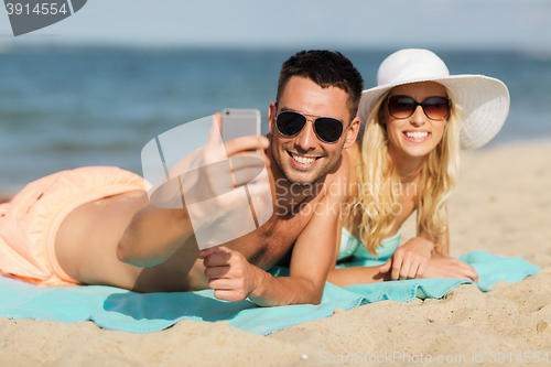 Image of happy couple in swimwear walking on summer beach