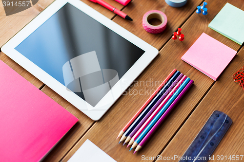 Image of close up of school supplies and tablet pc