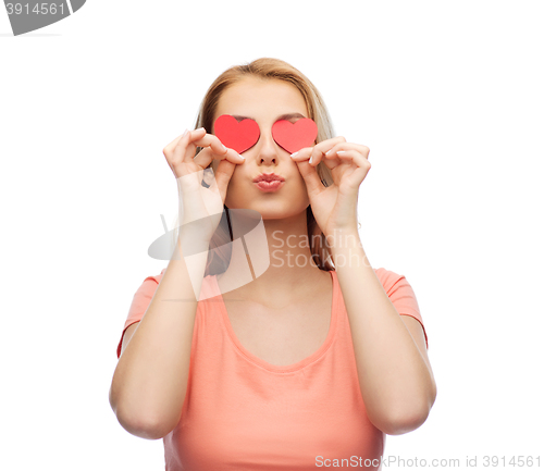 Image of happy young woman with red heart shapes on eyes