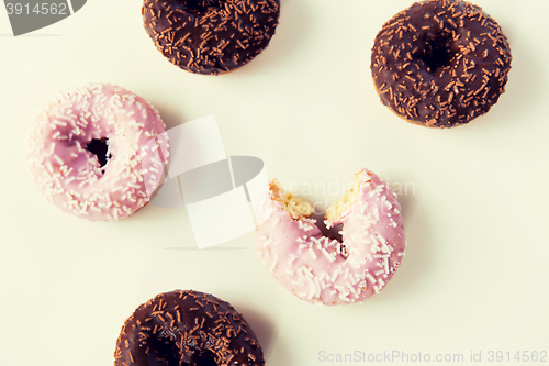 Image of close up of glazed donuts pile over white