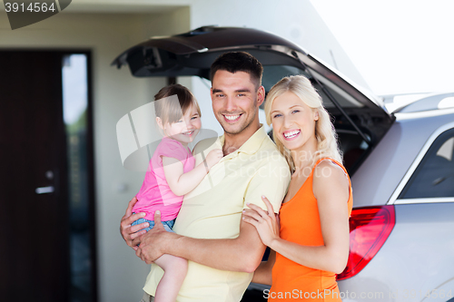 Image of happy family with hatchback car at home parking