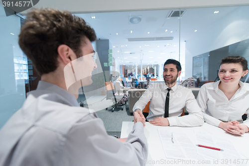 Image of young couple signing contract documents on partners back