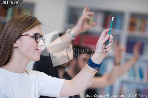 Image of group of students  raise hands up