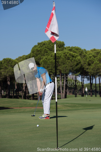 Image of golf player hitting shot at sunny day