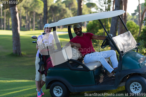 Image of couple in buggy on golf course