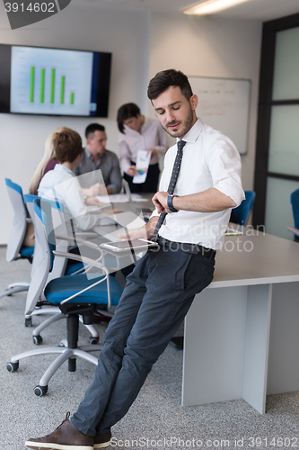 Image of young business man with tablet at office meeting room