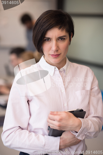 Image of hispanic businesswoman with tablet at meeting room