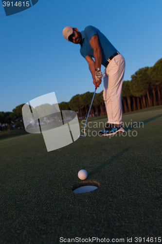 Image of golfer  hitting shot at golf course