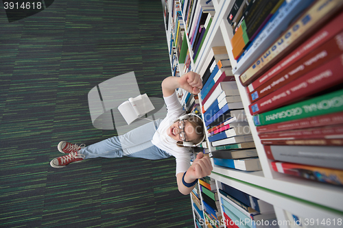 Image of female student study in library, using tablet and searching for 