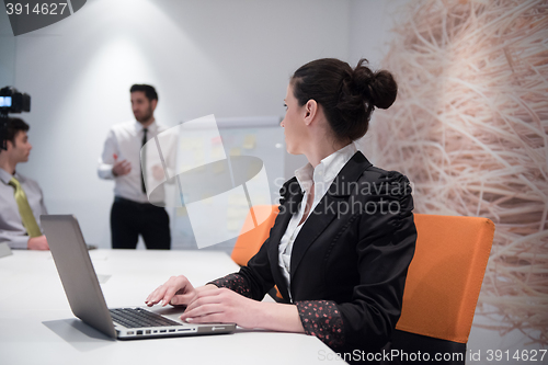 Image of young business woman on meeting  using laptop computer