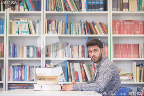 Image of portrait of student while reading book  in school library