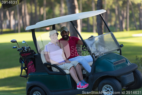 Image of couple in buggy on golf course